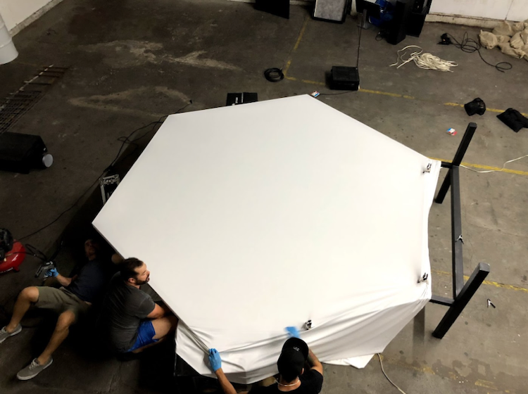 Stretching projection screen fabric over the final hexagon frame