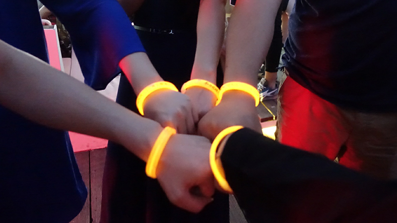 Attendees with glow in dark event bracelets