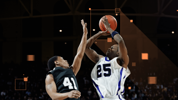 Reveal full-sized photo:  Basketball players on the court making a play