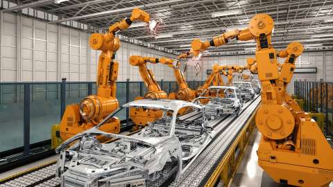 Four automobiles being assembled by articulated robots