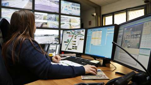 Woman monitors traffic surveilance cameras in milan, italy