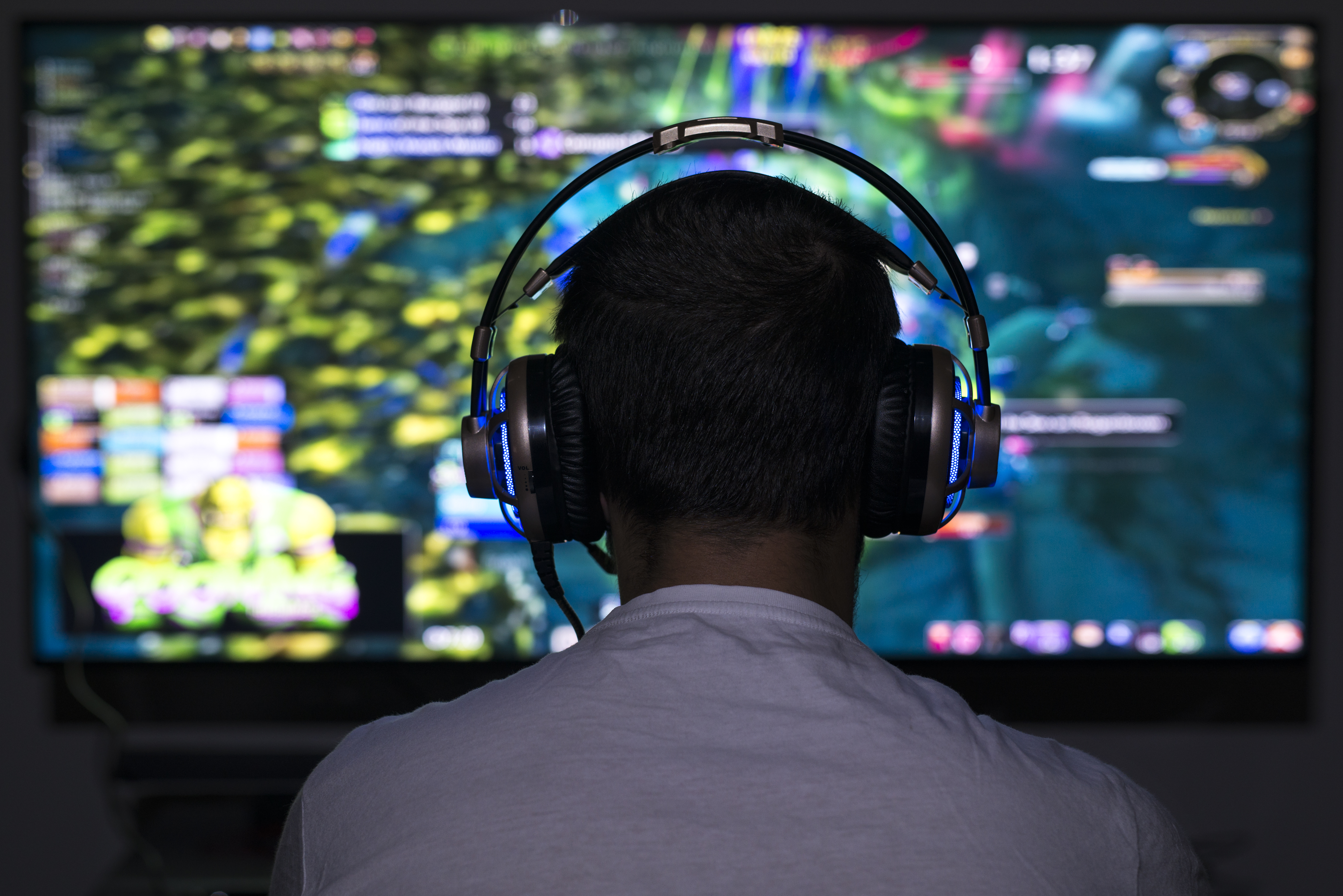 Gamer using a desktop PC and a large monitor
