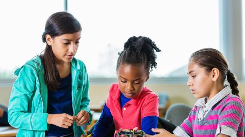 Three students working on robotics