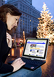 The 2004 holiday season is increasingly going digital, with notebook PCs among this year's hottest sellers. Julie Vhay is seen here shopping online while 'unwired' in downtown Portland, Oregon. According to recent holiday trend indexes, three out of four Americans plan to give a gift of technology this season.