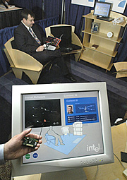 SENSORS TO HELP PEOPLE WITH DEMENTIA An Intel researcher holds a tiny battery-powered device that wirelessly collects data from sensors embedded in household items such as a floor mat or chair.  The device transmits data back to a home PC to alert a caregiver that a patient is trying to stand and leave the room. Wireless sensor networks could help people with illness maintain their independence, prevent disease and increase their quality of life. They were demonstrated Tuesday, March 16, 2004 to lawmakers in Washington, D.C. at the Technology Demonstration on Capital Hill hosted by the Center for Aging Services Technologies (CAST). (Feature Photo Service)