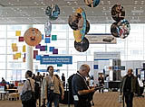 An attendee gets acquainted with the IDF Fall 2005 program guide on Level Two at Moscone West in San Francisco, Calif., on Monday, August 22, 2005. (Photo by Intel Press Relations)