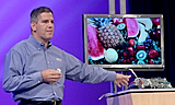 Donald J. MacDonald, Intel's Vice President, General Manager Digital Home Group, shows IDF attendees a new home entertainment high resolution screen using Intel technology during his keynote held at the Intel Developer Forum in San Francisco, Calif., on Wednesday, August 24, 2005. (Intel Press Relations)