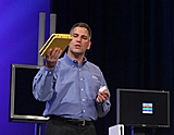 Donald J. MacDonald, Intel's Vice President, General Manager Digital Home Group, shows IDF attendees a new home entertainment device during his keynote held at the Intel Developer Forum in San Francisco, Calif., on Wednesday, August 24, 2005. (Intel Press Relations)