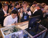 IDF attendees rush onto the stage for a close-up look at Intel lproducts and demos after the Technology and Research keynote at the Intel Developer Forum Fall 2005 at Moscone West on Thursday, August 25, 2005 in San Francisco, Calif. (Intel Press Relations)