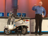 Intel’s Sean Maloney, executive vice president, general manager for the Intel’s Mobility Group, talks about a EVT electric scooter outfitted with WiMAX during his Intel Developer Forum Spring 2006 keynote held at the Moscone West in San Francisco, Calif., on Tuesday, March 7, 2006.