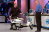 Intel employee Craig Raymond, left, and Sean Maloney, Intel Corporation Executive Vice President; General Manager, Mobility Group, right, show off an EVT electric scooter outfitted with WiMax during the Mobility keynote at the Intel Developer Forum at Moscone West on Tuesday, March 7, 2006 in San Francisco, Calif. 