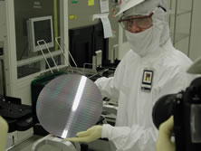 An Intel technician holds a wafer for the camera